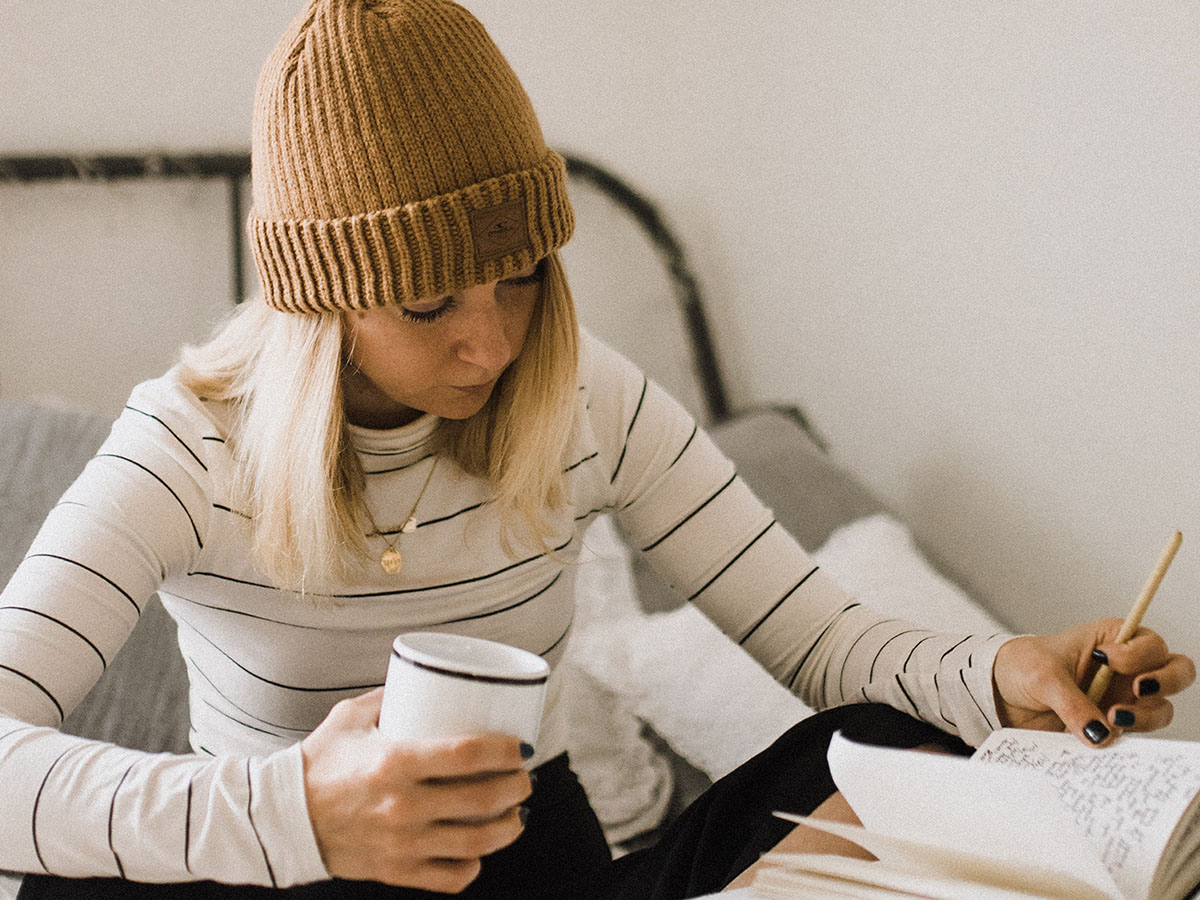 Image of a college student with a book and coffee