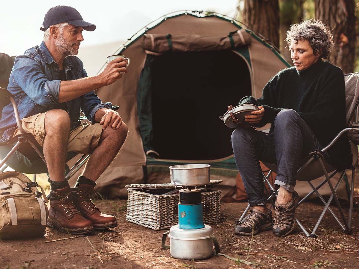 2 people camping with coffee