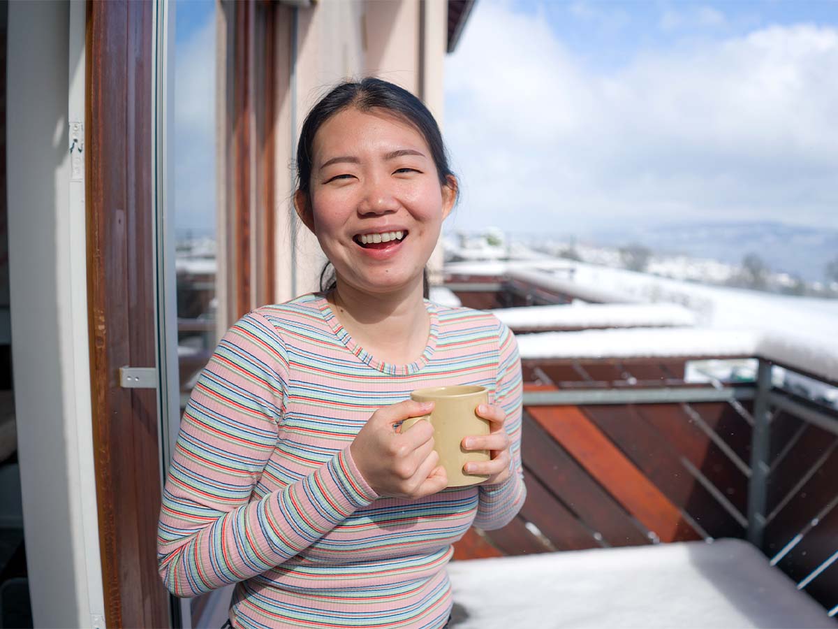 Girl on her balcony with coffee