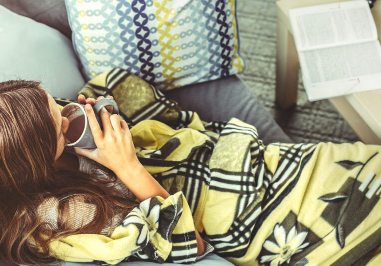 Image of a girl drinking coffee with a book